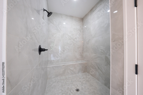 Bathroom shower has been updated with new ceramic tile and fixtures