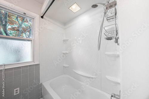 Bathroom shower has been updated with new ceramic tile and fixtures