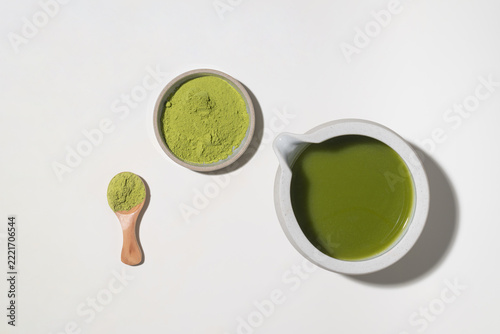 Vibrant green matcha powder and prepared tea in minimalist