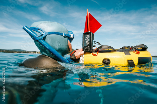 freediver checking sonar on a training buoy