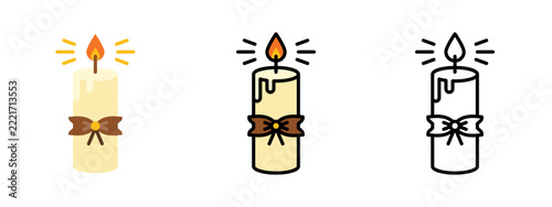 Decorative pillar candle glowing with a festive ribbon tied around its center