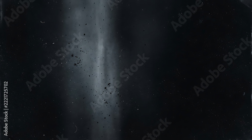 A dark and moody abstract background featuring a vertical beam of soft light cutting through the deep black shadows