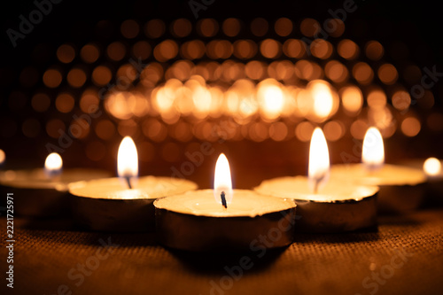 Glowing Candle Flame in Warm Bokeh for All Saints Day Memorial
