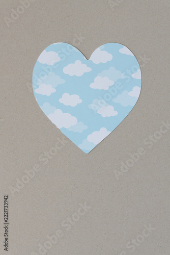 isolated paper heart with cloud pattern on cardboard