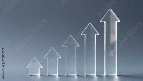 Five clear glass arrows showing upward trend on a dark background