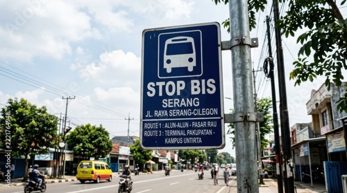 Street bus stop sign in Serang Indonesia with urban traffic and buildings in background