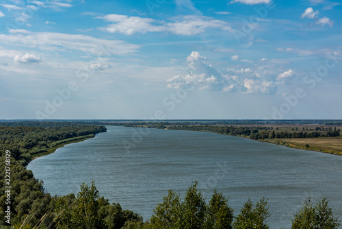 The Siberian river, wide and peaceful, draws bizarre loops between green banks