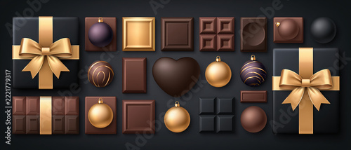 A luxurious assortment of dark and milk chocolates, elegantly arranged with golden ribbons and festive ornaments, suggests a gourmet indulgence or a special holiday gift.