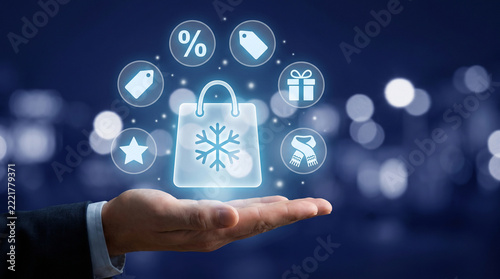 Glowing futuristic winter shopping icons and digital holographic bag levitating gently above human palm against blurred blue background with glowing bokeh lights