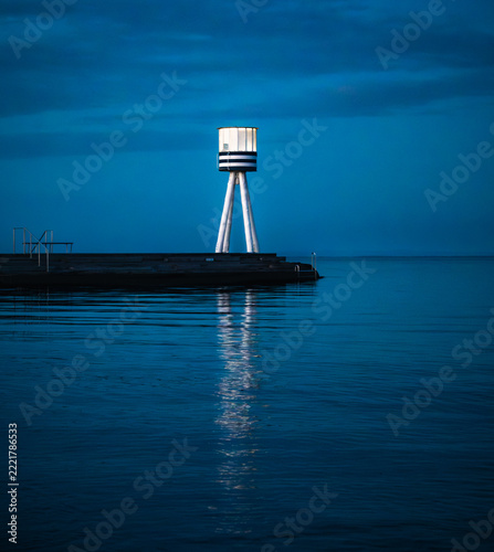 Futuristic White Beacon Over Blue Water