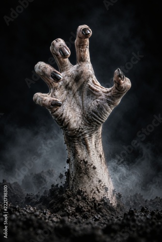 Weathered Undead Hand Reaching from Dark Soil Against a Smoky Background