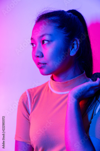 Asian Woman in Blue and Pink Neon Light, Close-Up Portrait