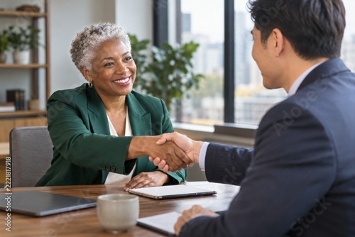 Mature Black Businesswoman Shaking Hands with a New Professional Partner