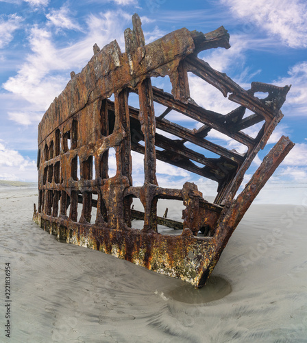 The Peter Iredale, a four masted steel hulled transport ship, built in England, round aground in 1906 and remains on the shore of the Oregon Coast in the Pacific Ocean.