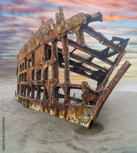 The Peter Iredale, a four masted steel hulled transport ship, built in England, round aground in 1906 and remains on the shore of the Oregon Coast in the Pacific Ocean.