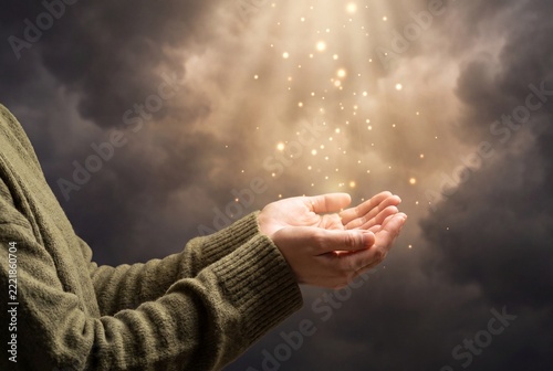 Person Holding Open Hands Upward to Receive Divine Light and Grace