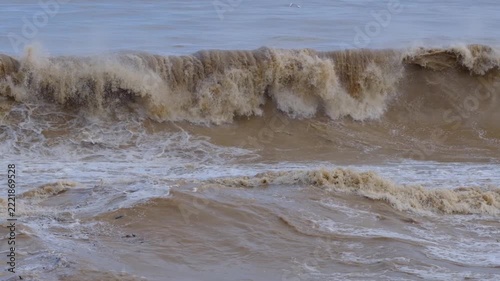 Powerful Brown Sea Waves During a Storm. Rough Muddy Sea Waves Surging in Stormy Weather. Turbulent Brown Ocean Water with Strong Waves.
