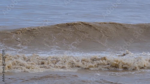 Powerful Brown Sea Waves During a Storm. Rough Muddy Sea Waves Surging in Stormy Weather. Turbulent Brown Ocean Water with Strong Waves.