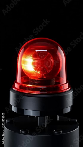 Red emergency siren beacon flashing on black background
