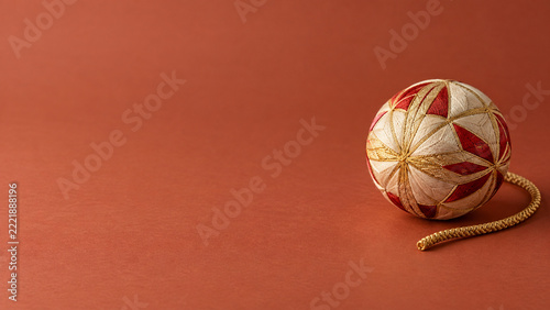 Ivory Red and Gold Temari Ball on Terracotta Background