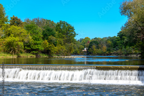 Photography Scenic river with a small artificial waterfall in nature