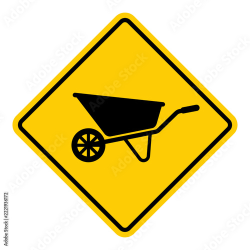 Wheelbarrow caution sign in black silhouette on yellow background  