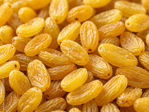 dried yellow raisins on a white background. macro.