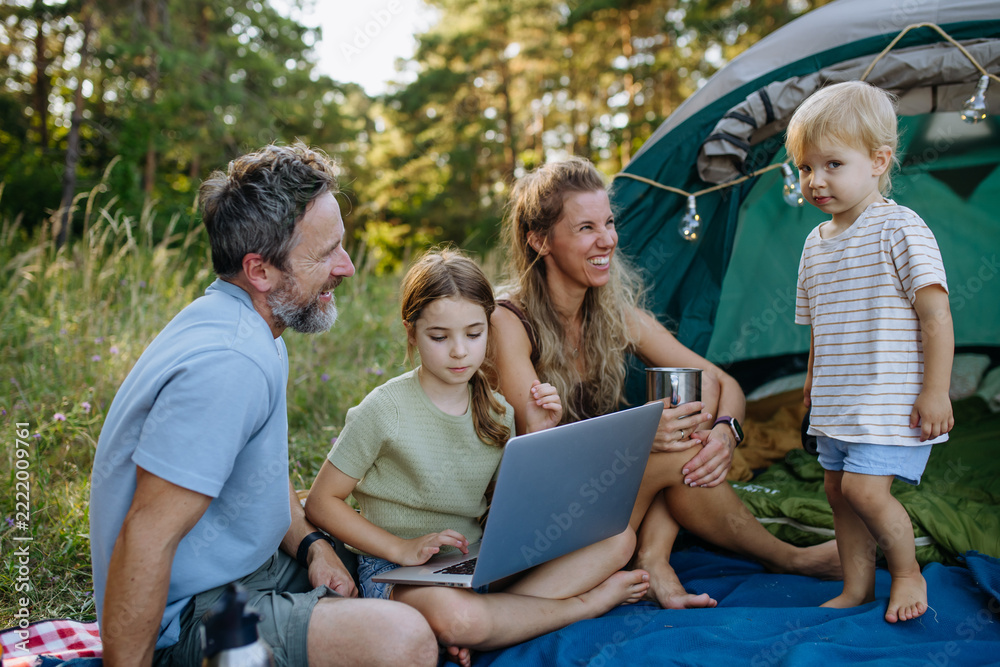 Fototapeta premium Happy family spending time together during autumn camping trip.