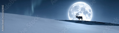Reindeer standing on a snowy hill under a large full moon, with faint aurora borealis in a dark blue night sky, arctic landscape scenery