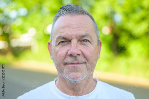 Confident mature man outdoor portrait smiling