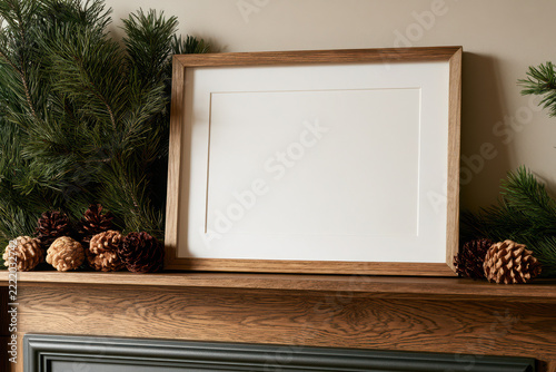 Horizontal Wood Picture Frame Mockup on Rustic Mantel with Pine Branches and Cones, Winter Holiday Blank Poster Display Template Home Art Decor.