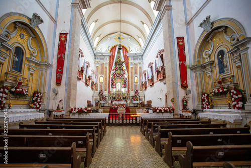 Interior view of Igreja de Nossa Senhora dos Remedios in historic Paraty Brazil showing pews and altar