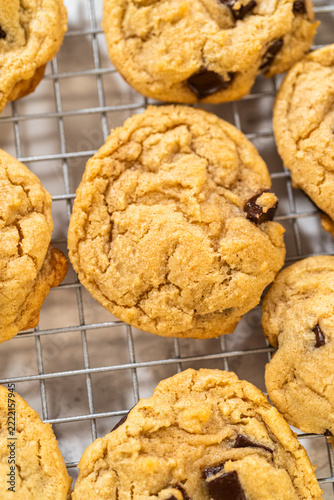 Chocolate chip cookies cooling on metal rack