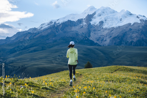  Trail runner running on the high altitude grassland mountain top