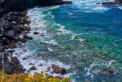 Clear water over algae-covered boulders