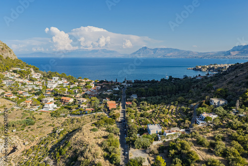 Aerial drone view of Cape Zafferano in Sicily, Italy, showing rugged rocky coastline of the Tyrrhenian Sea with crystal clear turquoise water, small islands and beautiful Mediterranean landscape.