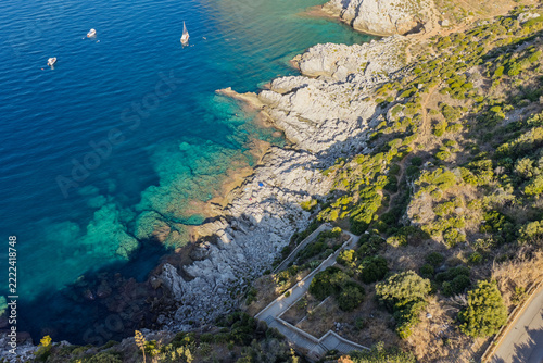 Aerial drone view of Cape Zafferano in Sicily, Italy, showing rugged rocky coastline of the Tyrrhenian Sea with crystal clear turquoise water, small islands and beautiful Mediterranean landscape.