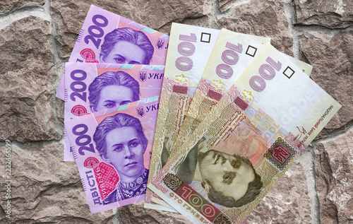 Hryvnia Ukrainian national currency on a black background. Beautiful money of Europe	
