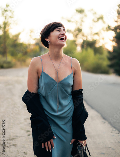 Happy Middle-Aged Woman Laughing Outdoors, Authentic Joy, Positive Lifestyle and Natural Beauty Portrait