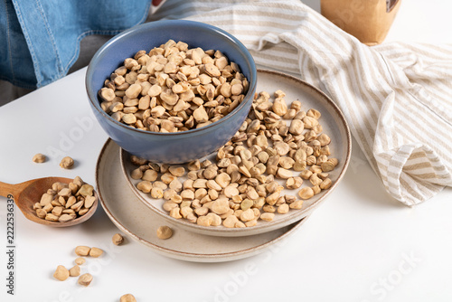 Died Grass Peas in ceramic bowl and plates. Traditional Mediterranean legumes called also chickling peas, chickling vetch, Indian pea, vetch. Plant protein source