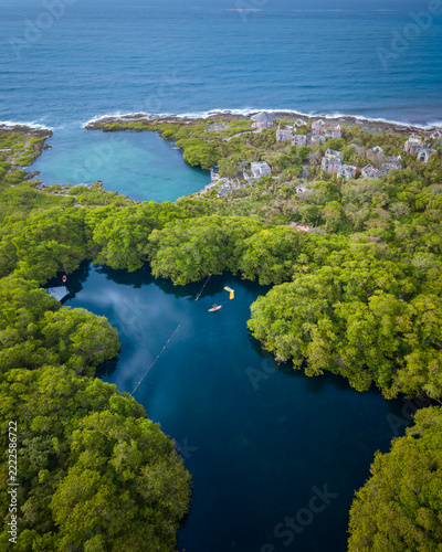 An abandoned resort in Cancun blend into the turquoise Caribbean Sea and Cenote