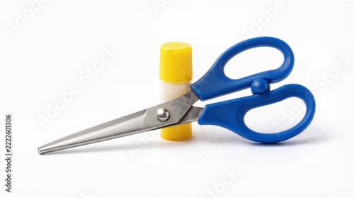 Blue handled scissors and yellow glue stick on white background