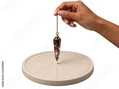 Hand holding smoky quartz pendulum over circular dowsing board