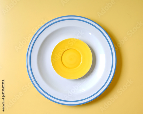 Stack of colorful clean plates on color background.