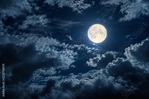 Bright Full Moon Shines through Drifting Blue Clouds in a Dark Night Sky