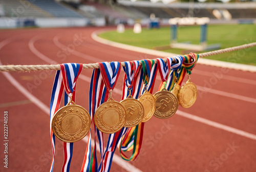 Gold medals hanging at running track finish line