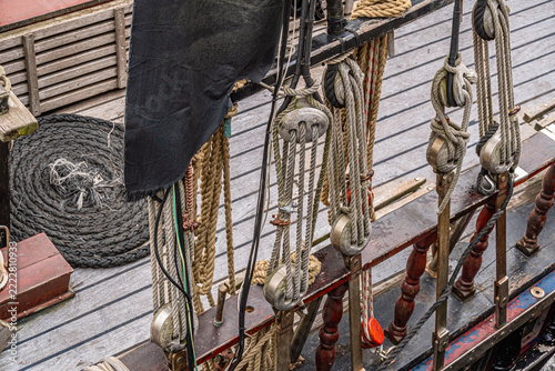 Ropes, pulleys, and rigging on old sailing ship deck