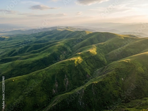 Aerial View of Rolling Emerald Green Mountain Ridges at Sunset
