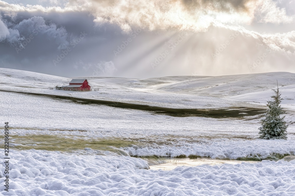 Fototapeta premium Snowy mountain landscape with red cabin and sunbeams