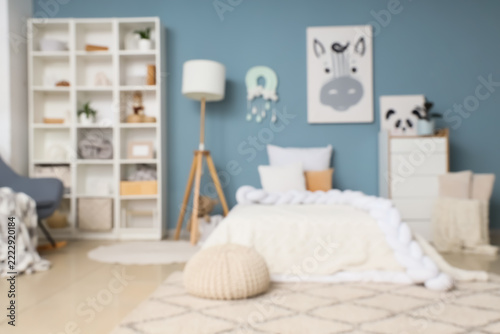 Modern nursery interior design, cozy bedroom for baby with blue walls and whi...